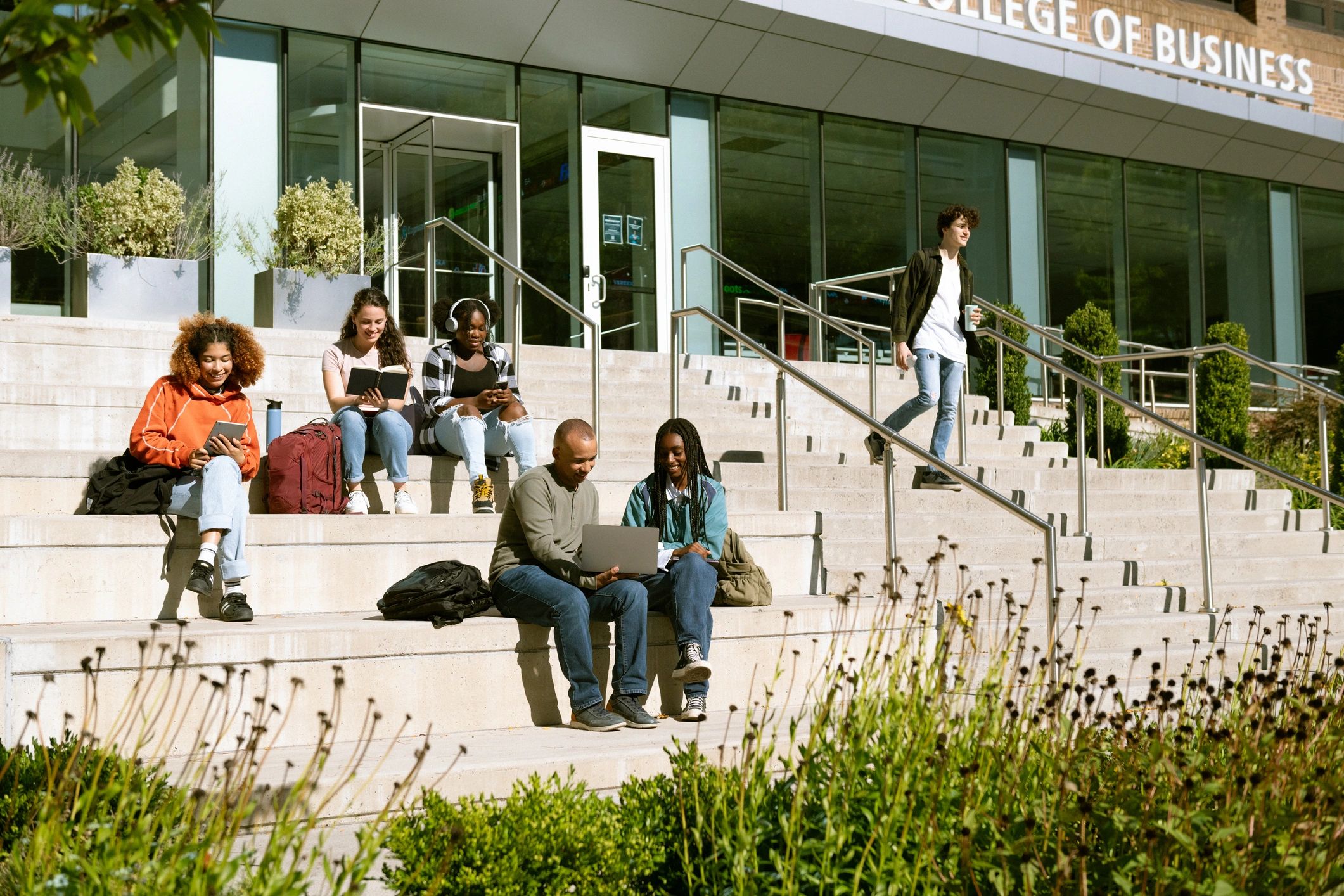 Students collaborating outside a university building