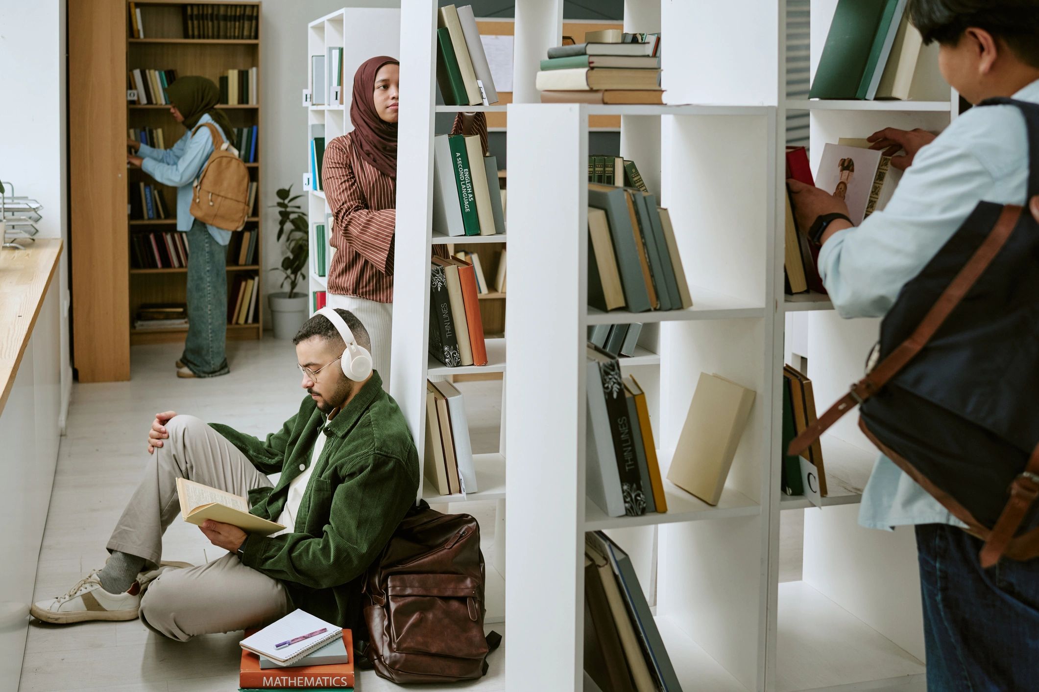 Diverse college students studying in a library